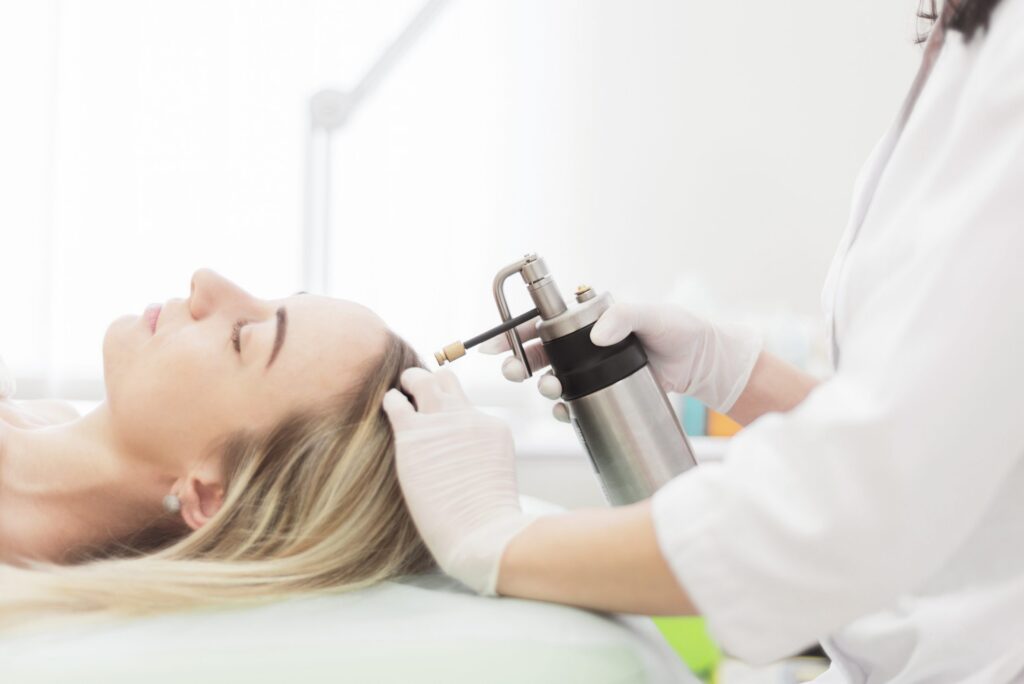 physician using liquid nitrogen on patient scalp