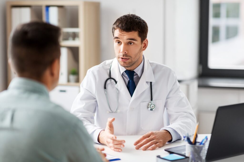 physician speaking with man about procedure