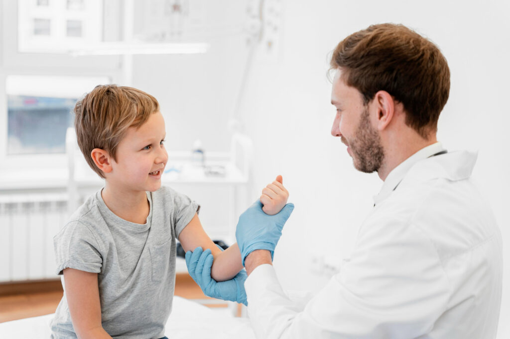 physician holding child's arm