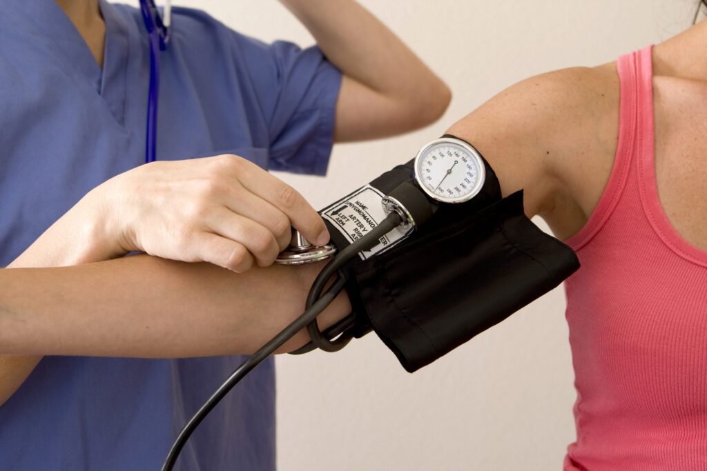 closeup of female patient having blood pressure checked