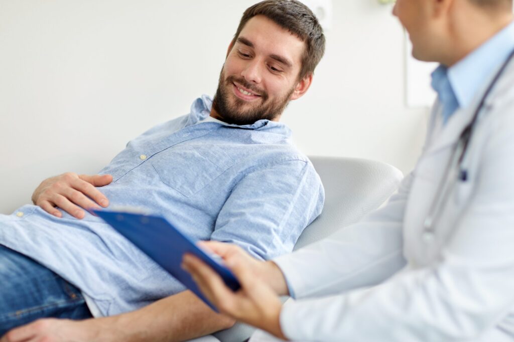 smiling male patient viewing medical chart with physician