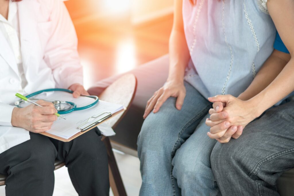 closeup of couple holding hands in anticipation of medical chart results